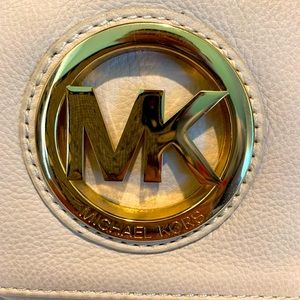 Michael Kors Cream Colored Pebbled leather clutch with gold logo